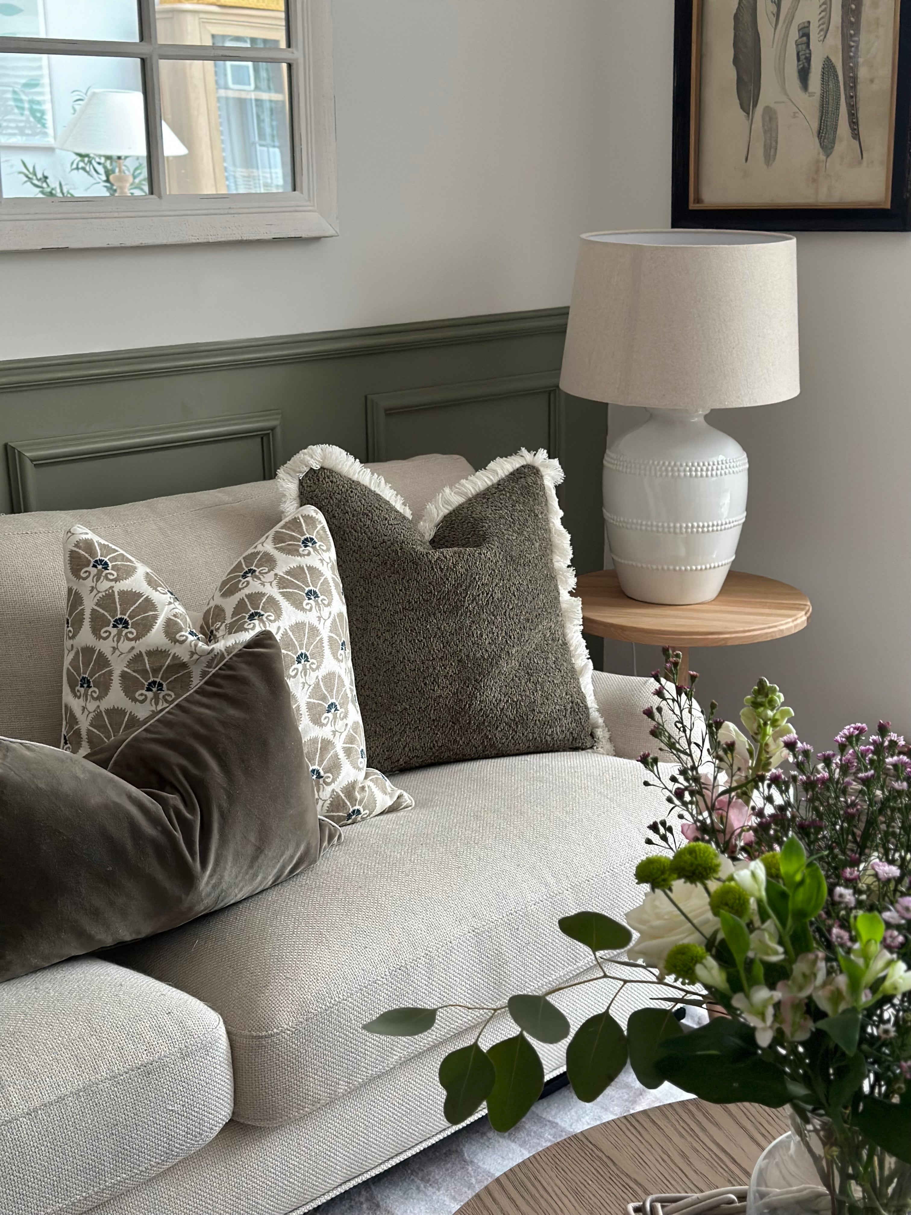 Lucia White Ceramic Table Lamp with beaded detailing and linen shade styled in living room