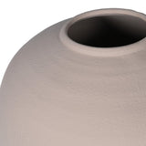 A large round beige vase filled with a narrow opening