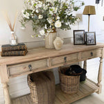 Three-drawer console table made from reclaimed, weathered pine