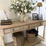Three-drawer console table made from reclaimed, weathered pine