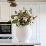 A stunning matte white round pot. Featuring a narrow neck line to support stems perfectly