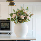 A stunning matte white round pot. Featuring a narrow neck line to support stems perfectly