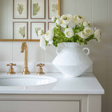 Introduce timeless elegance to your space with the “Arlo” White Ceramic Vase, a beautifully crafted piece that blends form and function. Featuring a striking geometric silhouette and distinctive double side handles, this modern ceramic vase makes a bold statement while maintaining a clean, minimalist aesthetic. Its matte white finish and sculptural shape make it an ideal accent for bathroom vanities, entryway consoles, or styled shelves. Perfect for lovers of modern, coastal, or farmhouse décor, the Arlo va