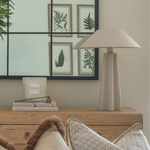 Modern beige metal table lamp in a living room setting