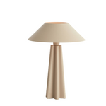 Beige table lamp with a cylindrical base and conical shade on a white background