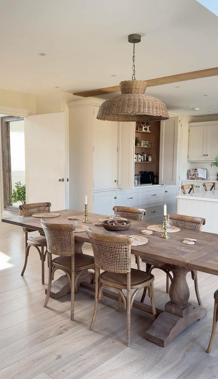 Caledonia rattan ceiling light styled above rustic dining table in neutral-toned kitchen