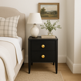 Indulge in the sophisticated design of our Carmen Dark Stained Solid Oak Bedside Table. Exquisitely crafted with two drawers in dark stained solid oak and oak veneer, its curved front and legs create a luxurious silhouette. The visible grain adds a touch of organic beauty, while the metal runners and brass style round handles offer a touch of opulence. Elevate your bedroom with this elegant and exclusive piece.