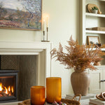 Living room with fireplace, candles, and decorative items.