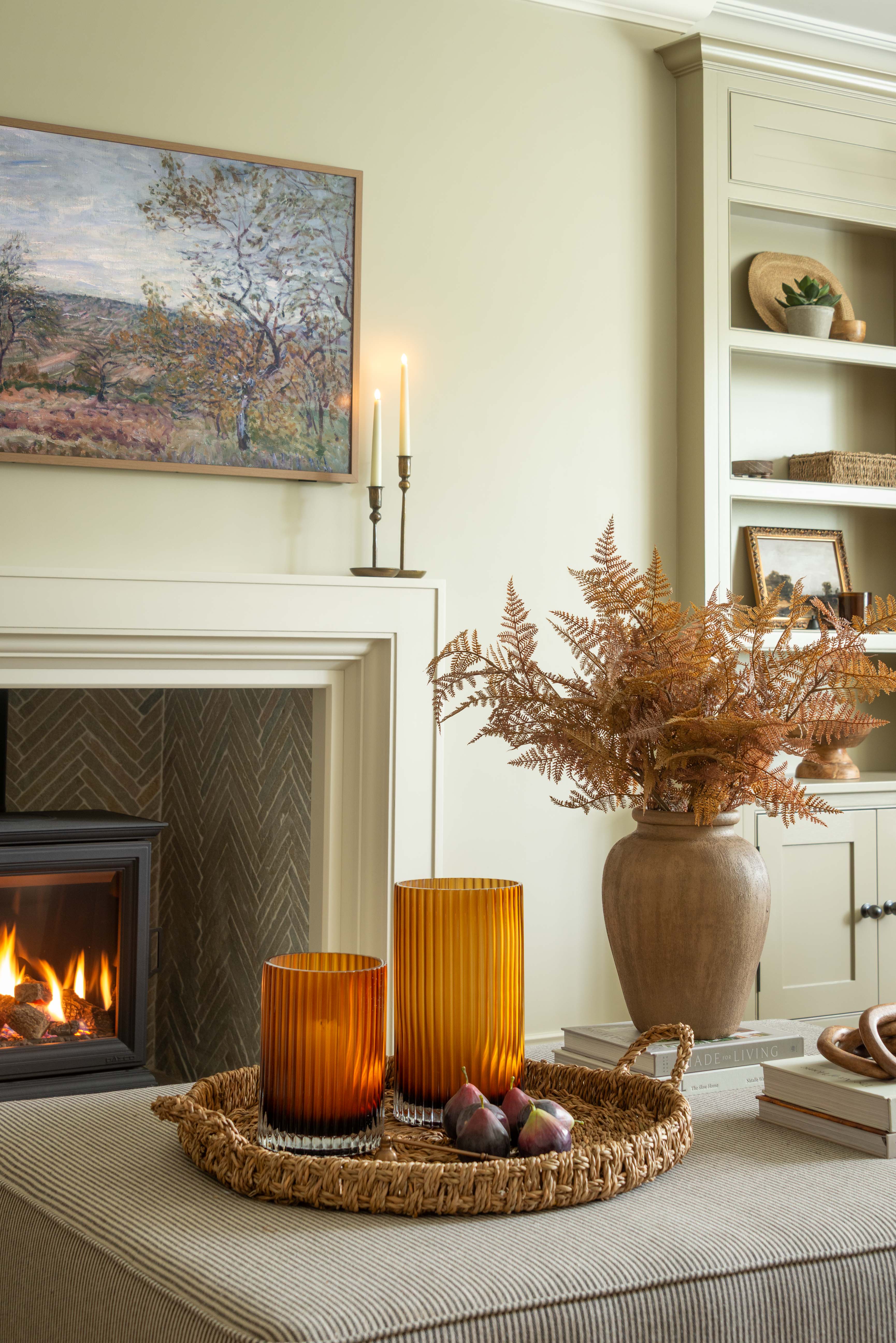 Living room with fireplace, candles, and decorative items.