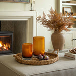 Living room with fireplace, candles, and decorative items.