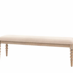 Beige upholstered bench with turned wooden legs and a minimalist design, ideal for entryways or bedrooms.