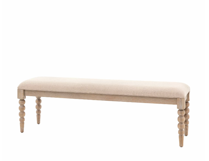 Beige upholstered bench with turned wooden legs and a minimalist design, ideal for entryways or bedrooms.