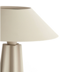Beige table lamp with a white shade on a white background