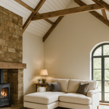 Cozy living room with a fireplace, beige sectional sofa, and large window.