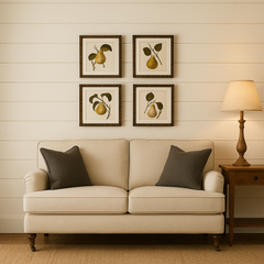 Beige sofa with gray pillows in a room with framed artwork on the wall and a lamp.