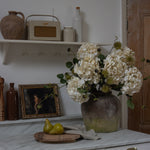 Faux chestnut spray with spiky pods in a vase