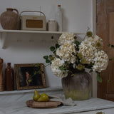 Faux chestnut spray with spiky pods in a vase