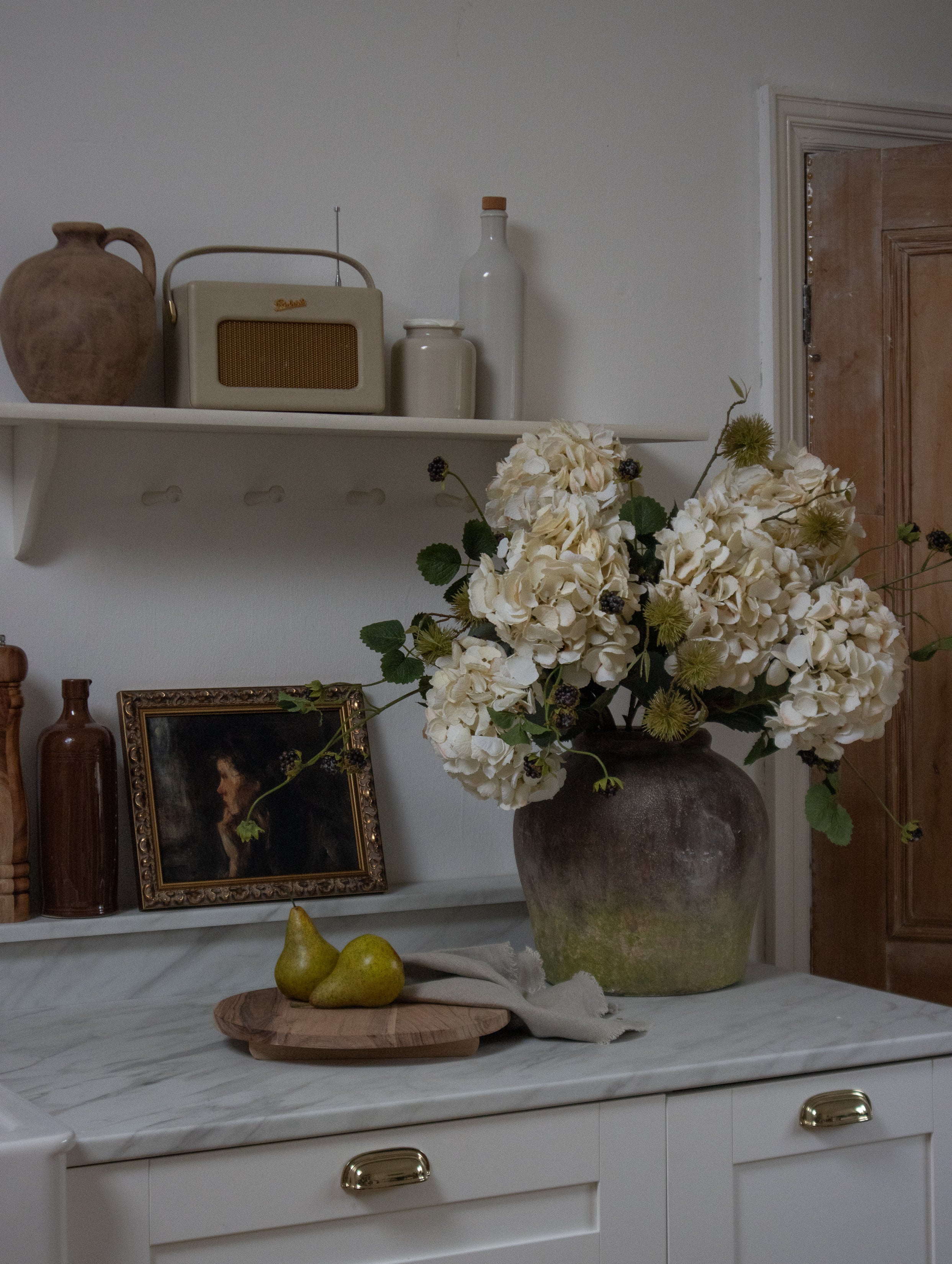 Faux chestnut spray with spiky pods in a vase