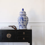 Charles Ted Chinoiserie Pot With Lid in blue and white porcelain featuring floral and elephant motifs on a black console table