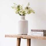 White ceramic vase with a slender bottle-neck design.