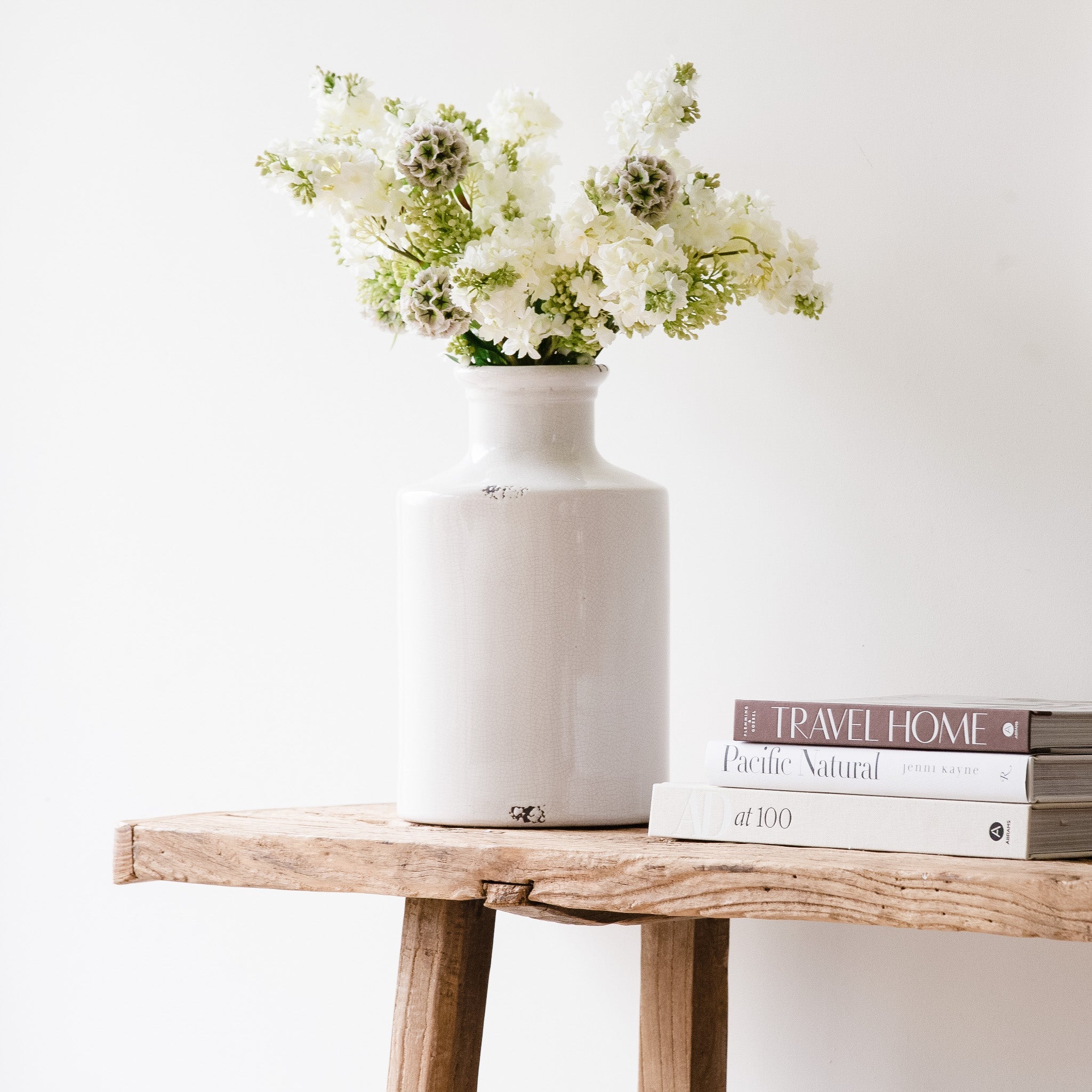 White ceramic vase with a slender bottle-neck design.