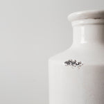 White ceramic vase with a slender bottle-neck design close up