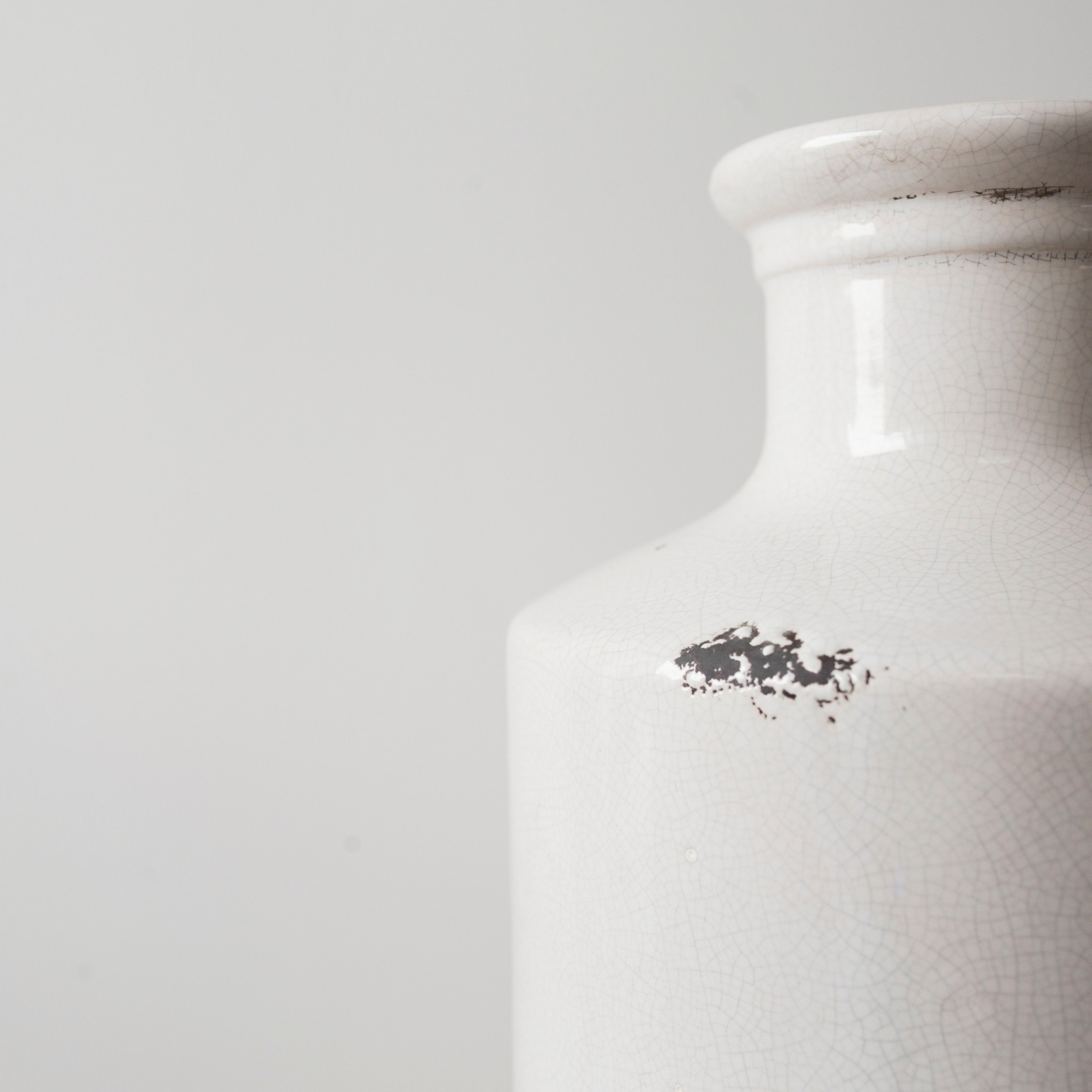 White ceramic vase with a slender bottle-neck design close up