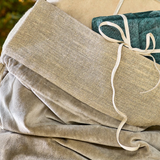 Gift sack made with grey velvet and rustic linen, stuffed with wrapped gifts close up