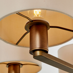 Close-up of a ceiling light fixture with a brownish-bronze finish.