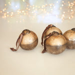 Charles Ted Gold Crackle Baubles set of four with foil finish and velvet ties displayed on a  tabletop