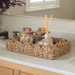 Bathroom vanity with a mirror, sink, and decorative items.