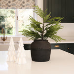 White lit decorative Christmas tree ornament by Charles Ted on a kitchen counter