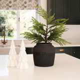 White lit decorative Christmas tree ornament by Charles Ted on a kitchen counter