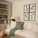 Framed pear wall art set displayed in a living room