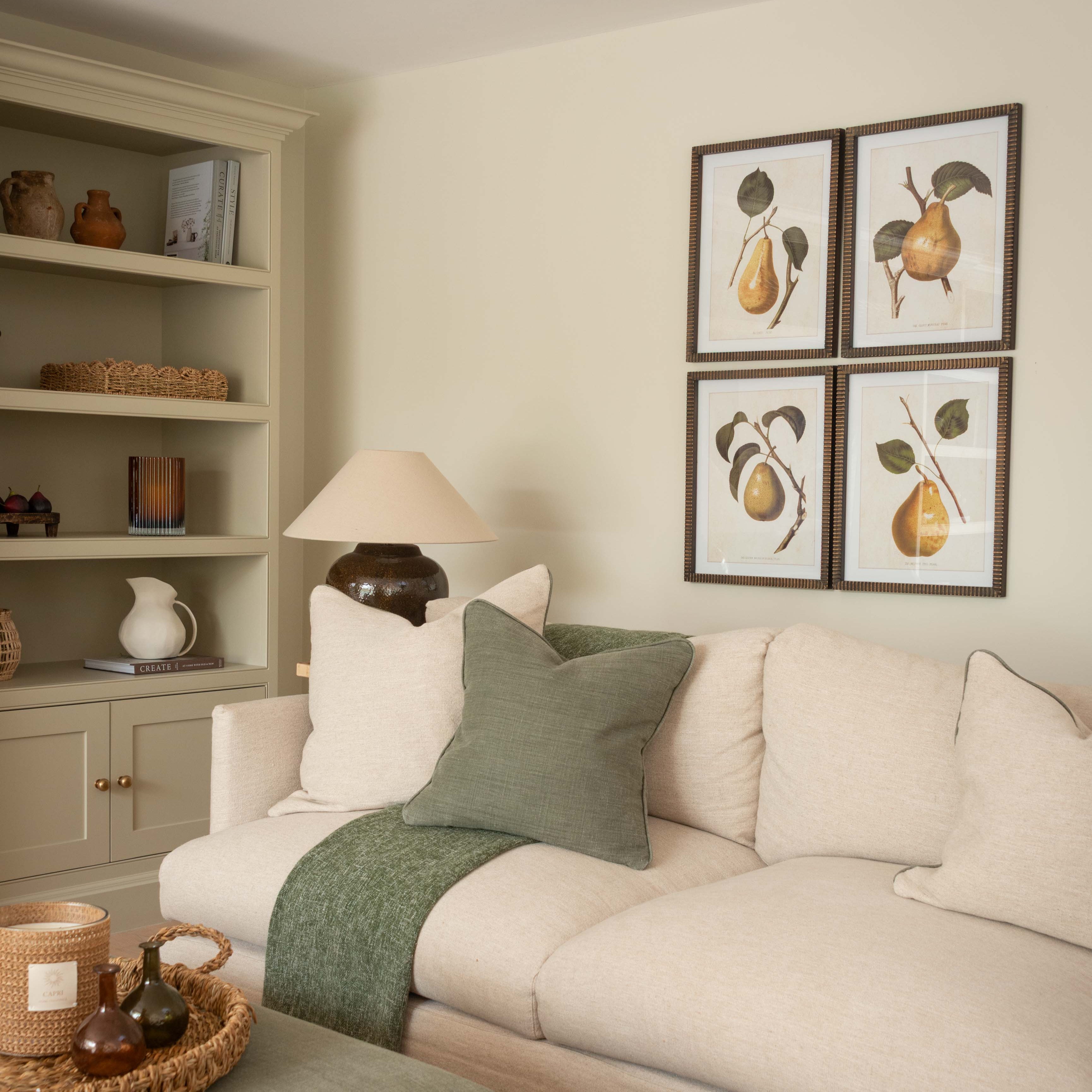 Framed pear wall art set displayed in a living room