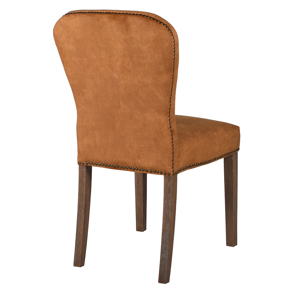 A stunning velvet chair in the warmest most beautiful tone of orange with brass stud detailing.