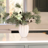 Charles Ted Scot's Pine Cone Spray with long pine needles and cones displayed in a white vase on a table