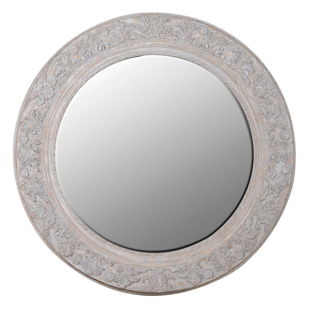 Round decorative mirror with intricate carvings on a white background