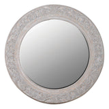 Round decorative mirror with intricate carvings on a white background