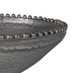 Close-up of beaded rim on porcelain metallic-effect bowl