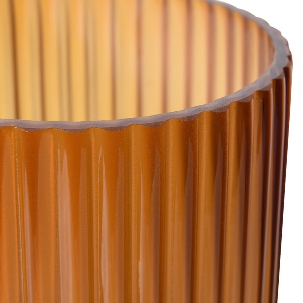 Close-up of ribbed amber ombre glass vase showing textured details