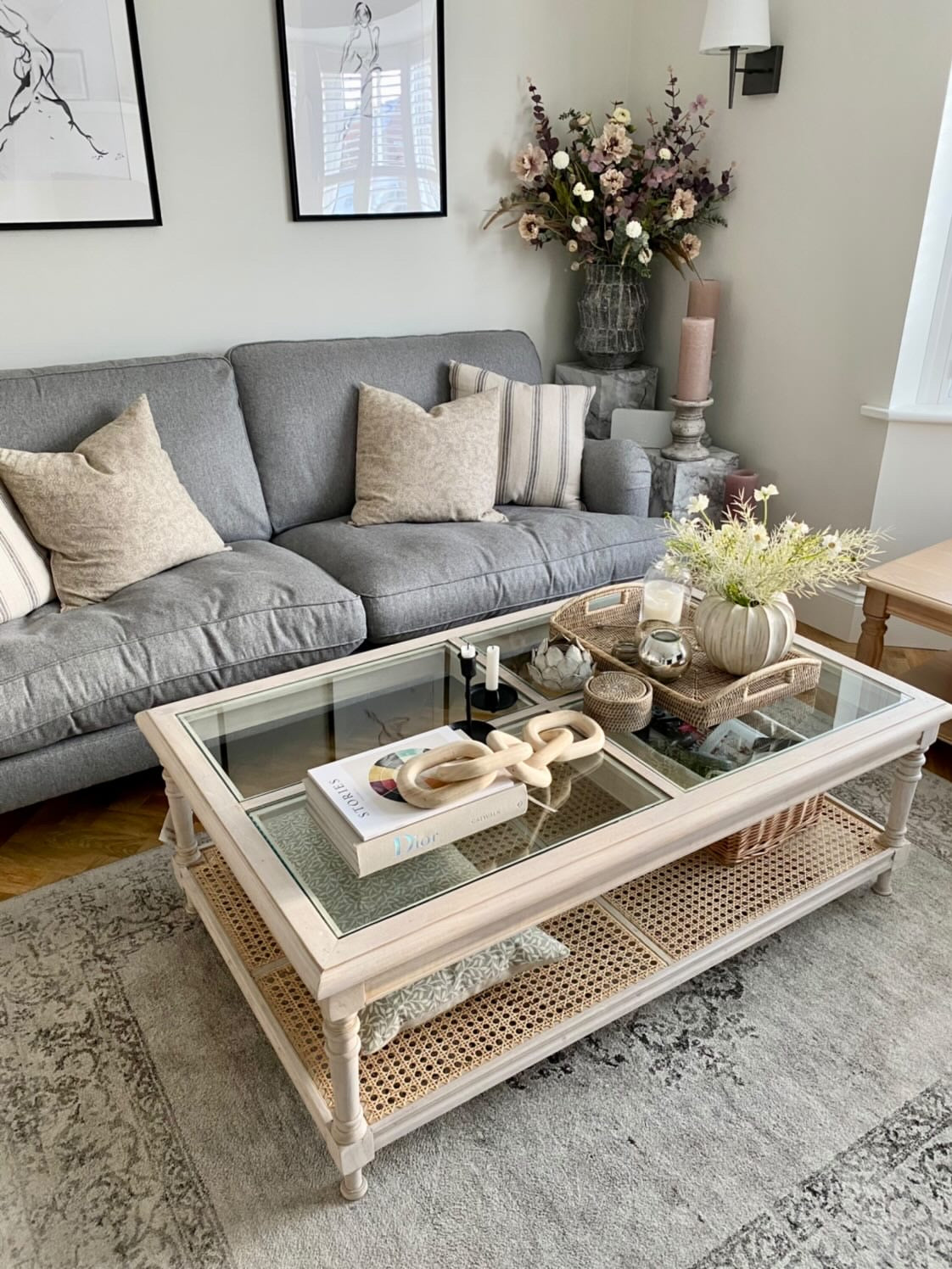 Rustic and elegant acacia wood coffee table with rattan and a glass top.