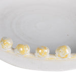 Close-up of handcrafted golden beaded rim on the Elara Decorative Ceramic Bowl