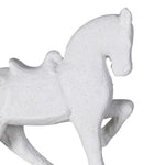 Close-up of textured white horse statue showing details of saddle and pose