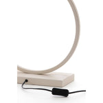 Cream circular metal base with black switch and cord