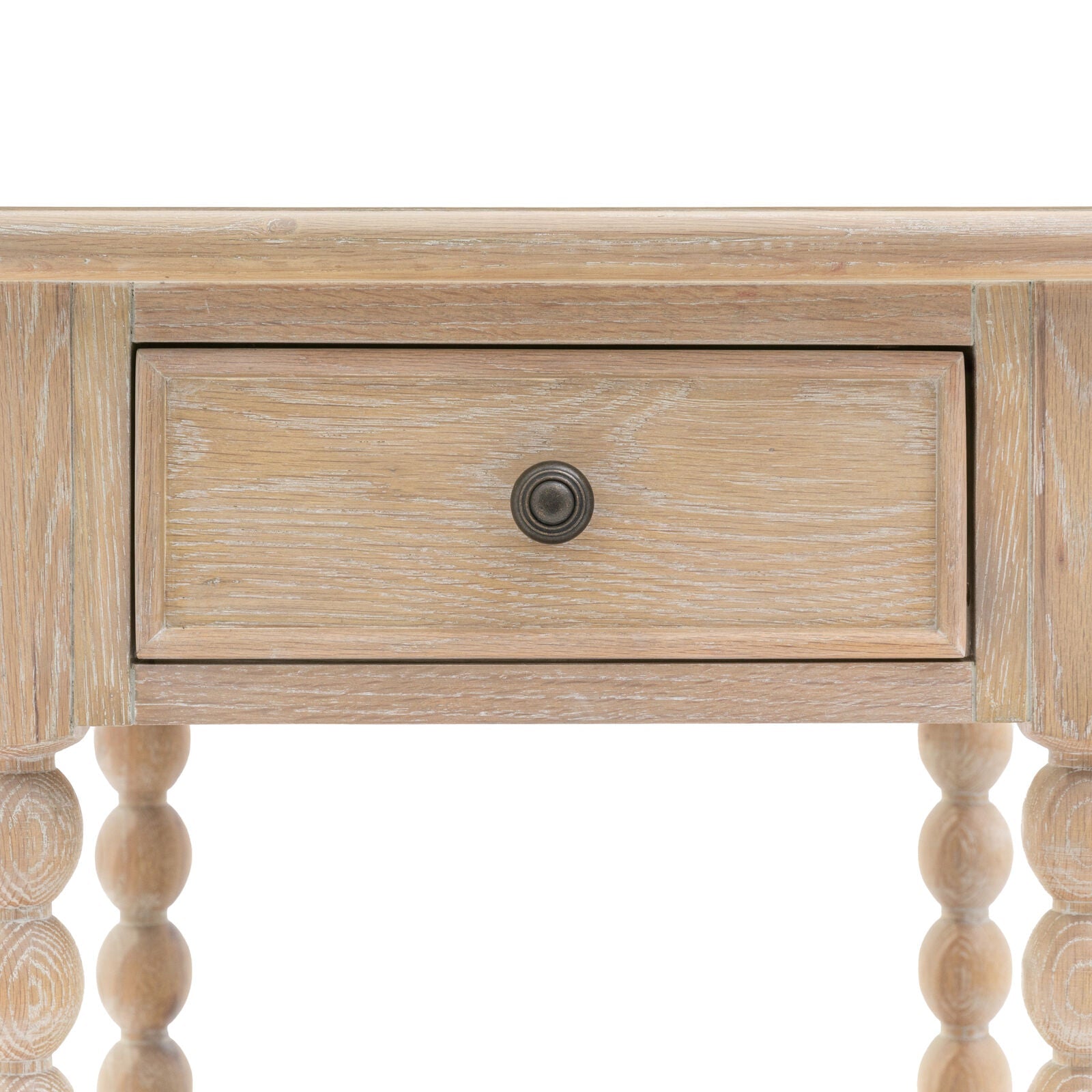 Antoine bedside table in limewashed oak with turned legs, single drawer, and open lower shelf – rustic and elegant bedroom furniture close up
