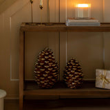 Decorative staircase with greenery, candles, and decorative items in a warm setting.