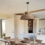 Caledonia rattan ceiling light styled above rustic dining table in neutral-toned kitchen
