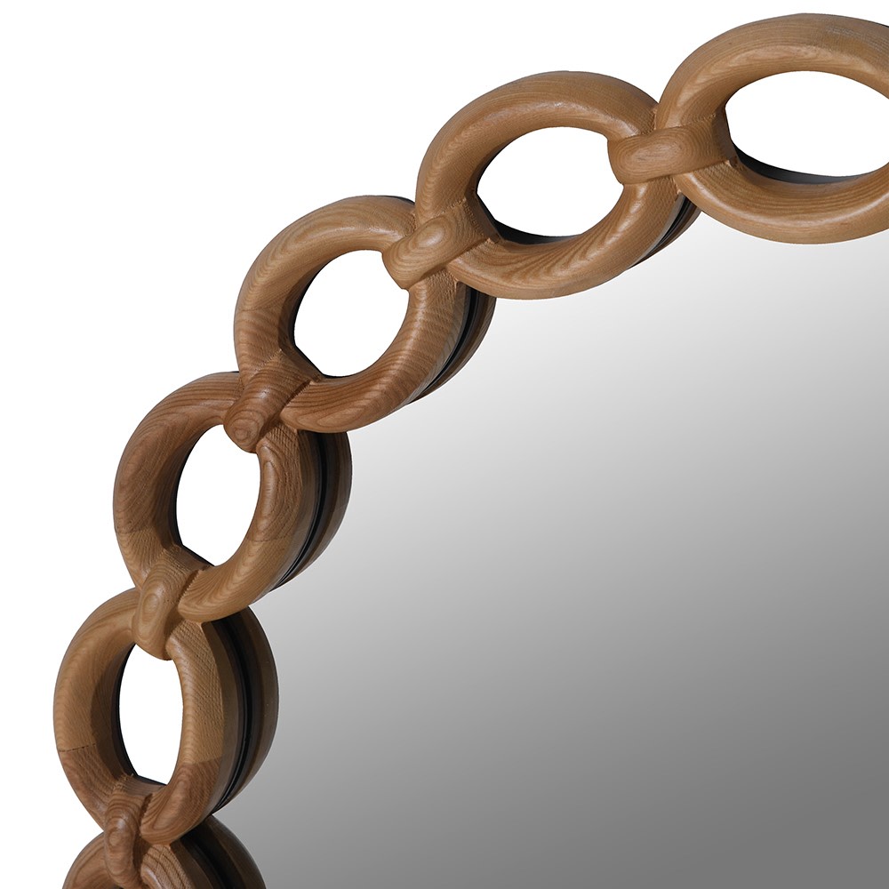 Close-up of chain-link wood frame on a round mirror, handcrafted from MDF with natural finish