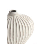 Ivory ribbed ceramic vase with rounded silhouette and modern textured design close up